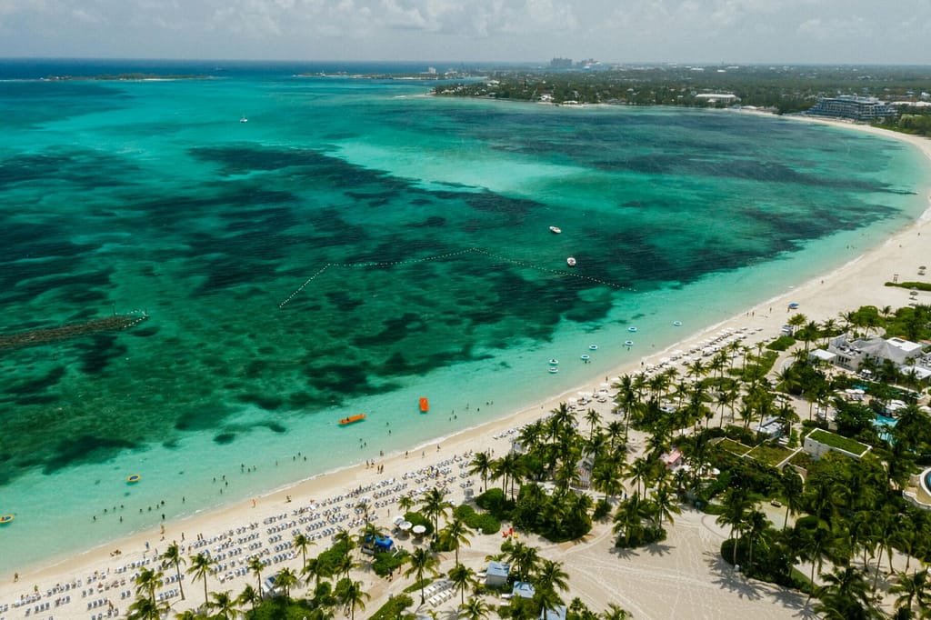 A stunning aerial shot of a tropical beach with turquoise waters and white sand, inviting relaxation.