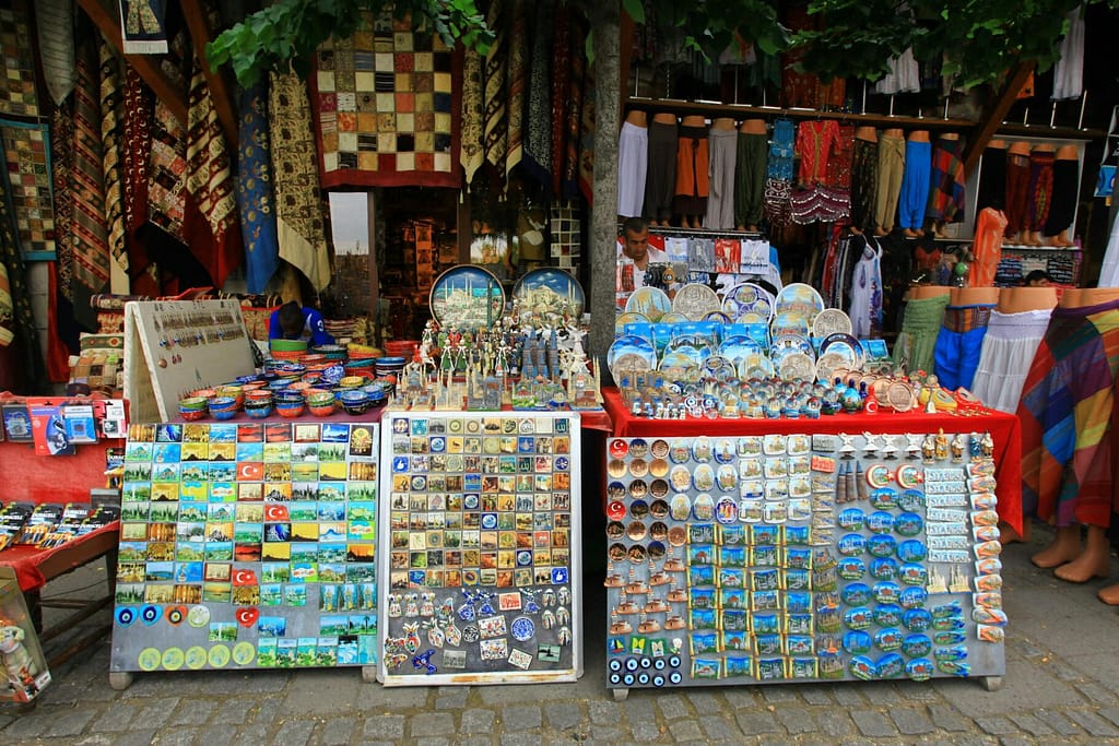 Colorful display of Turkish souvenirs and textiles at an outdoor market stall.