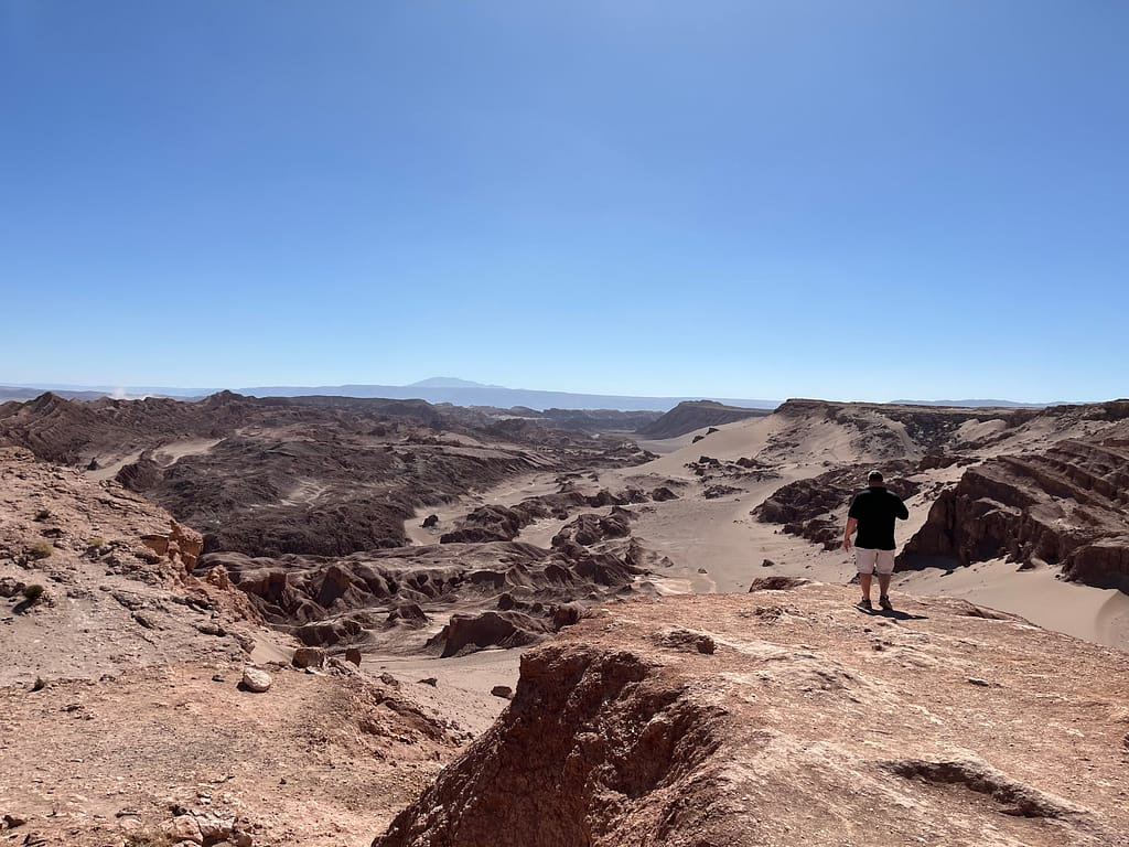 man looking at Valley of the Moon near San Pedro de Atacama, Chile