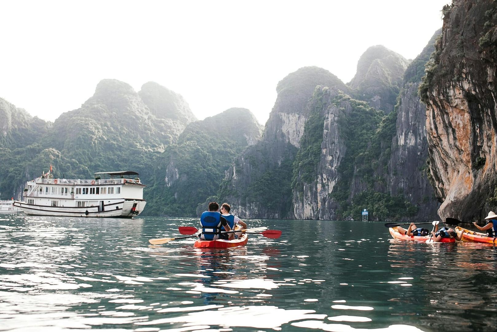 Explore the serene beauty of Ha Long Bay with limestone karsts and kayaking adventures.