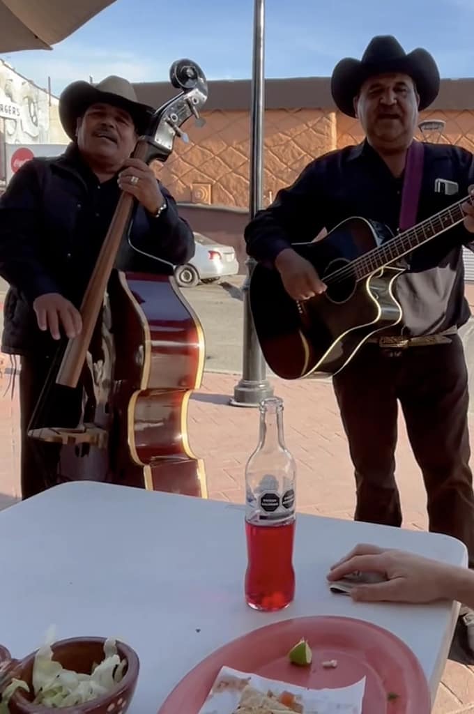 A bass player and a guitarist serenade diners in Mexico