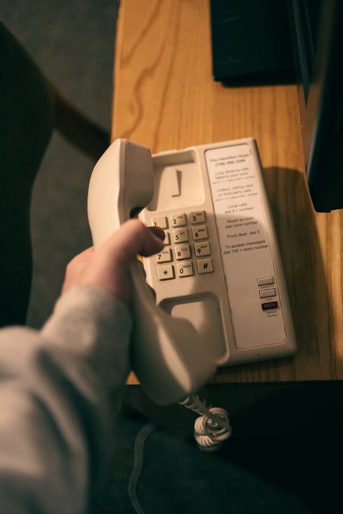 a person holding a landline phone