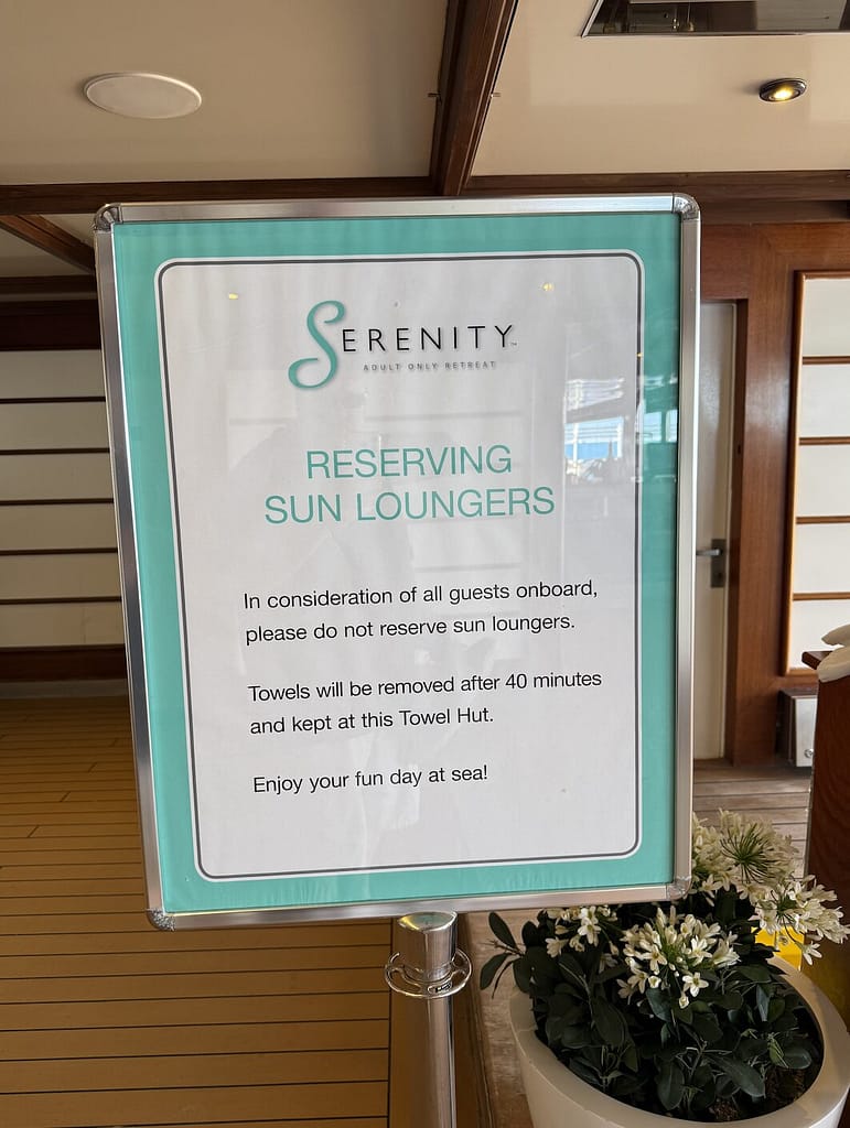 A sign in the Serenity Adult Retreat detailing Carnival’s chair reservation policy.