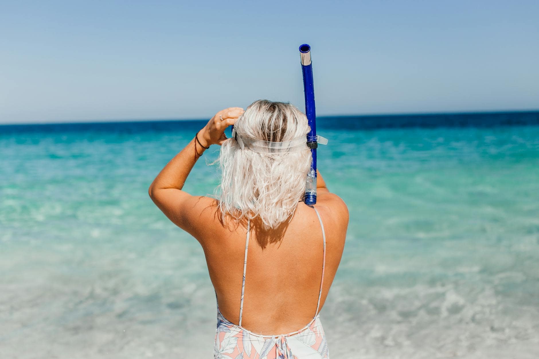 a person holding a snorkel/ Photo by Rachel Claire on Pexels.com