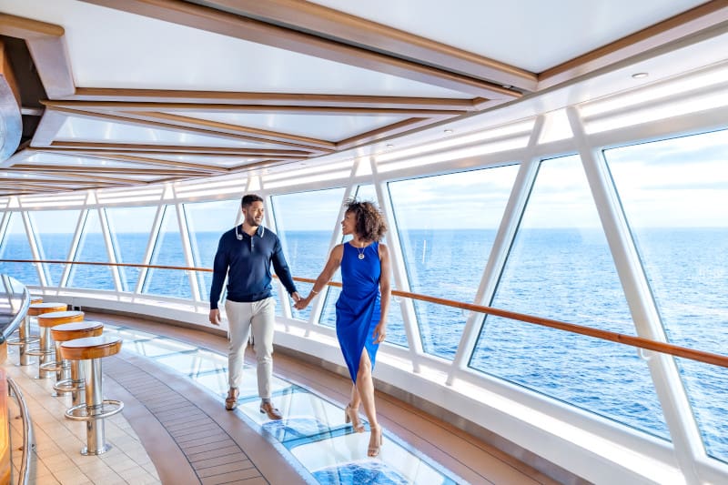A couple walking over the Sea Walk on Regal Princess cruise ship